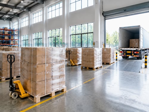 Dispatch-ready pallets positioned by a warehouse loading bay